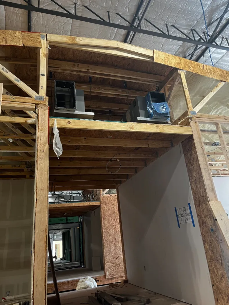 Inside a module, with wall framing and a finished wall section