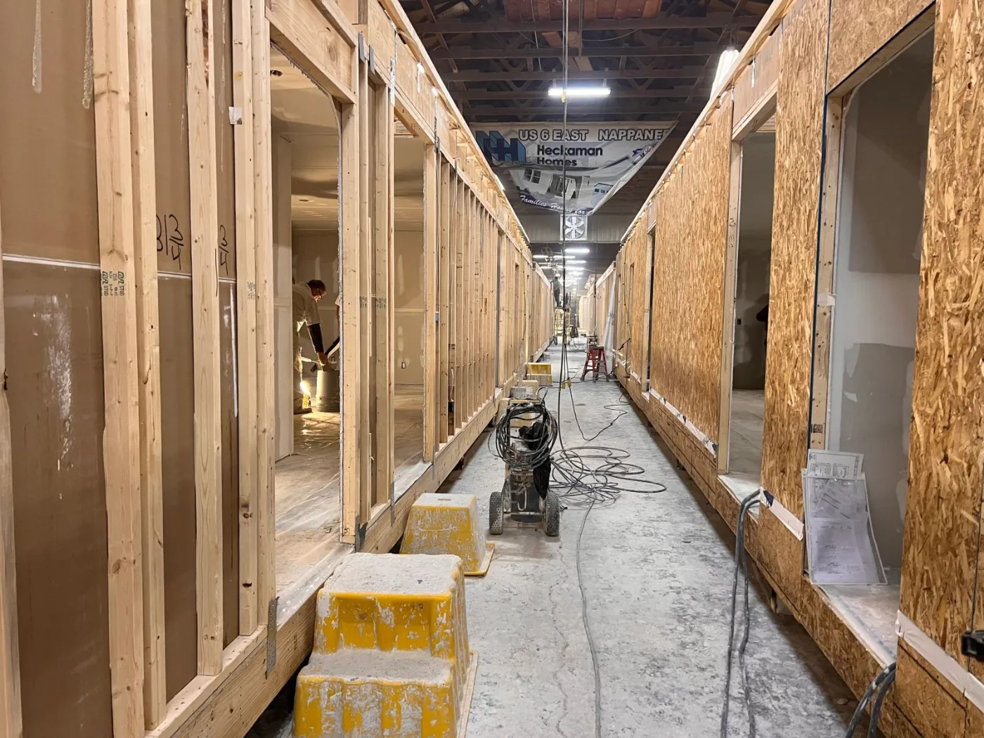 A row of framed modules along a factory aisle