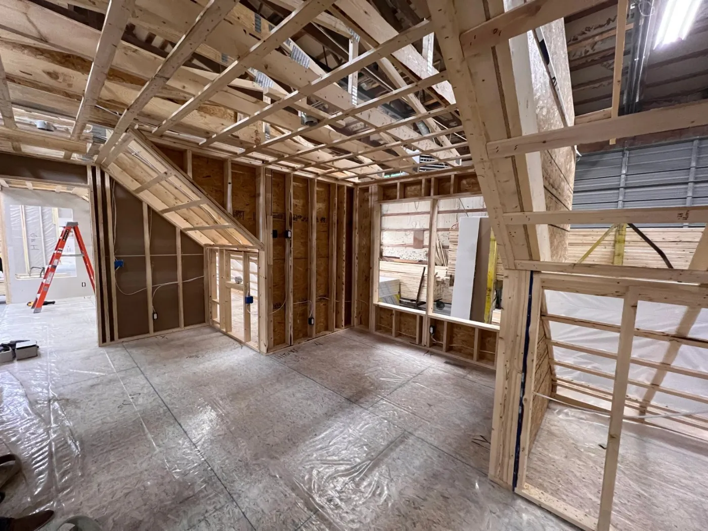 Inside a module during framing, with ceiling joists and wall studs