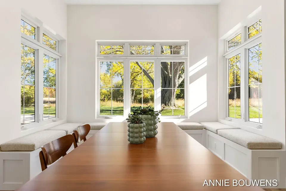 Dining nook with a built-in window bench and a wood table