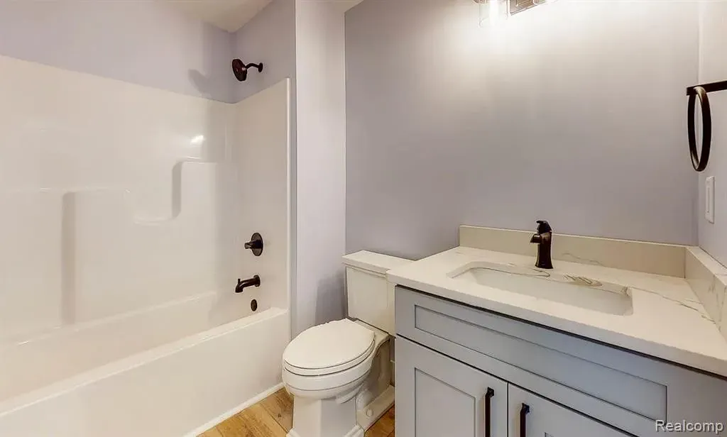 Bathroom with a gray vanity and a tub-shower