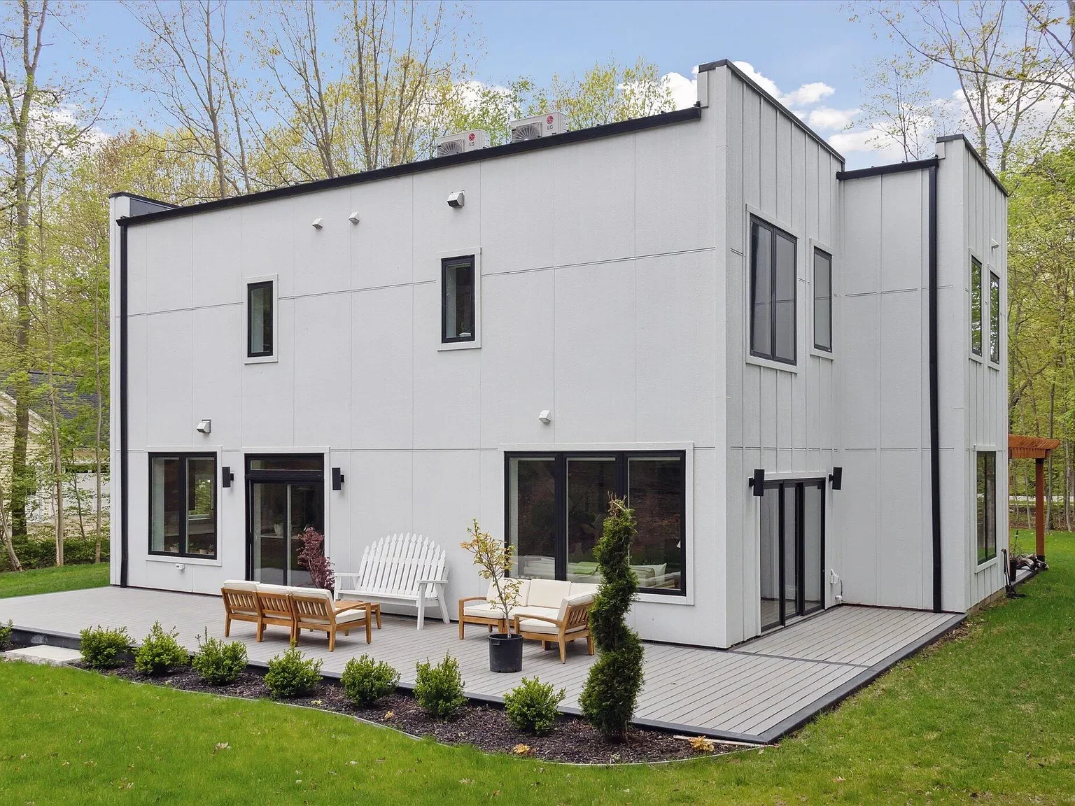 Rear of the home with patio seating and landscaping