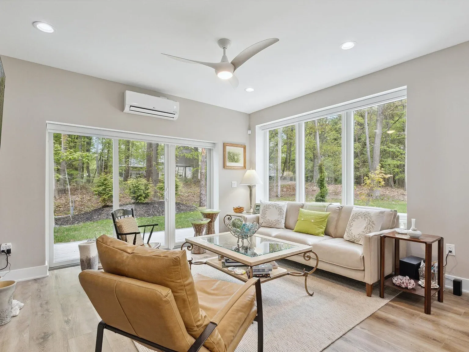 Living room with large sliding doors to the wooded backyard