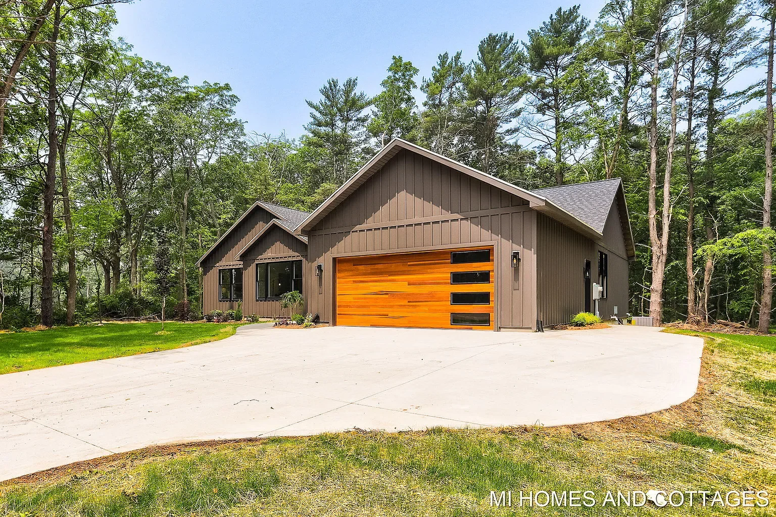 Front of the home showing the cedar garage door and curved concrete driveway