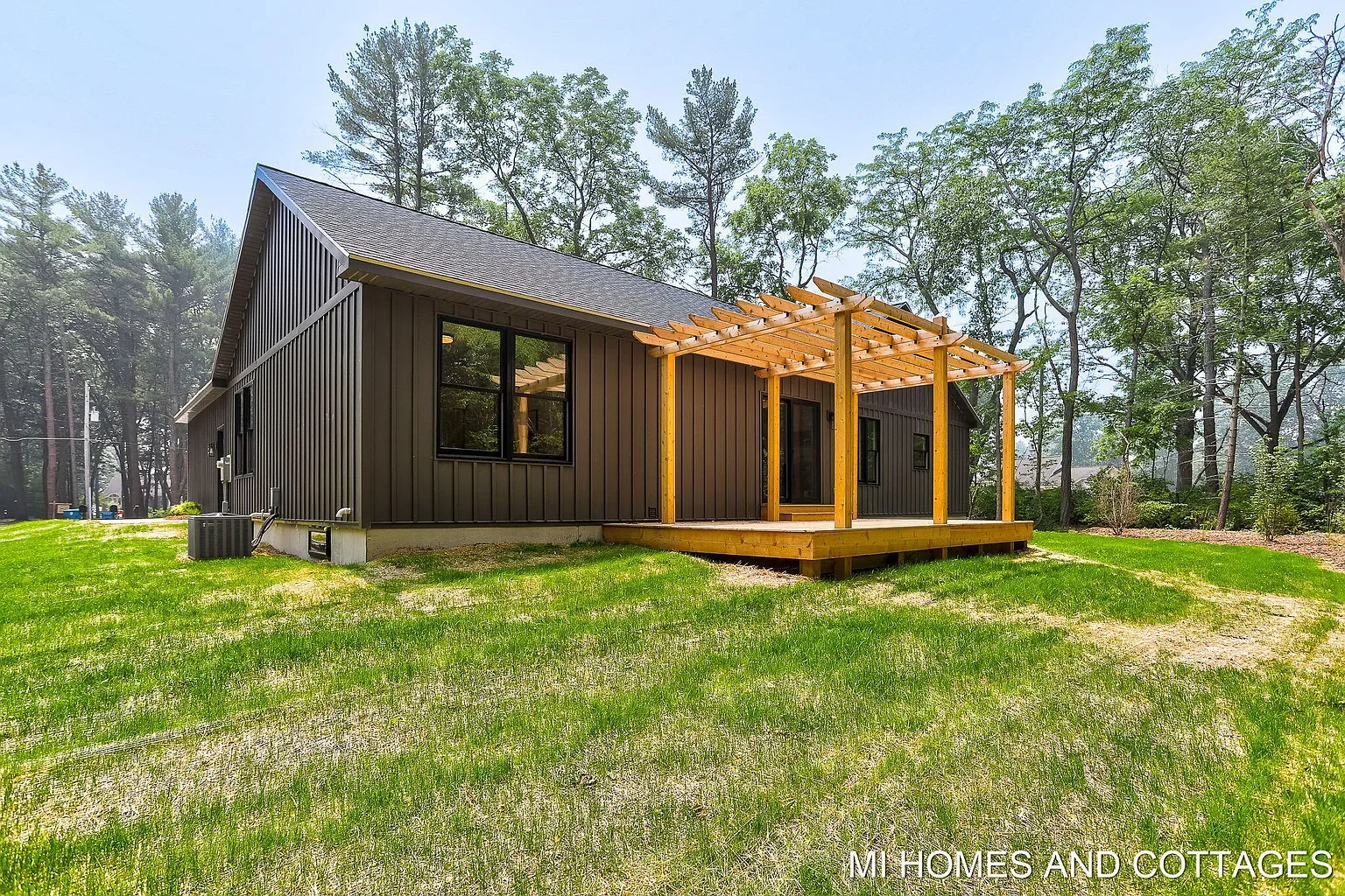Rear of the home with a cedar pergola and deck