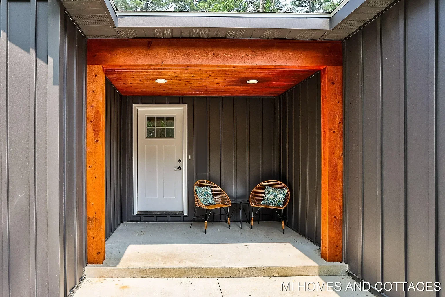 Covered front entry with cedar-wrapped framing and skylight