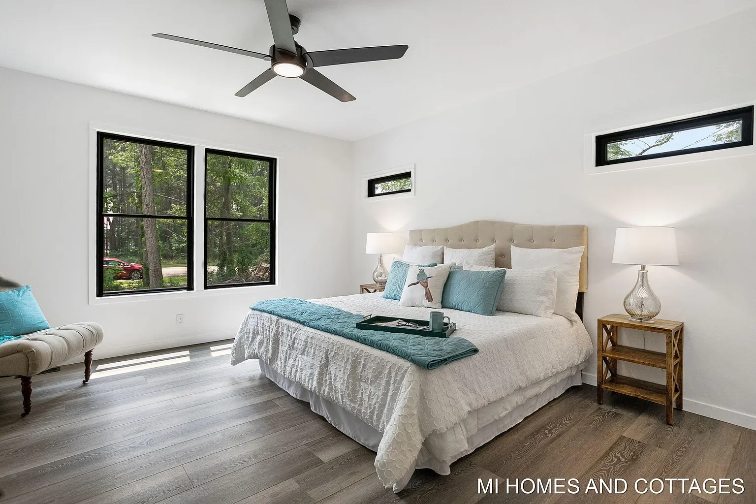 Primary bedroom with black-framed windows and clerestory window