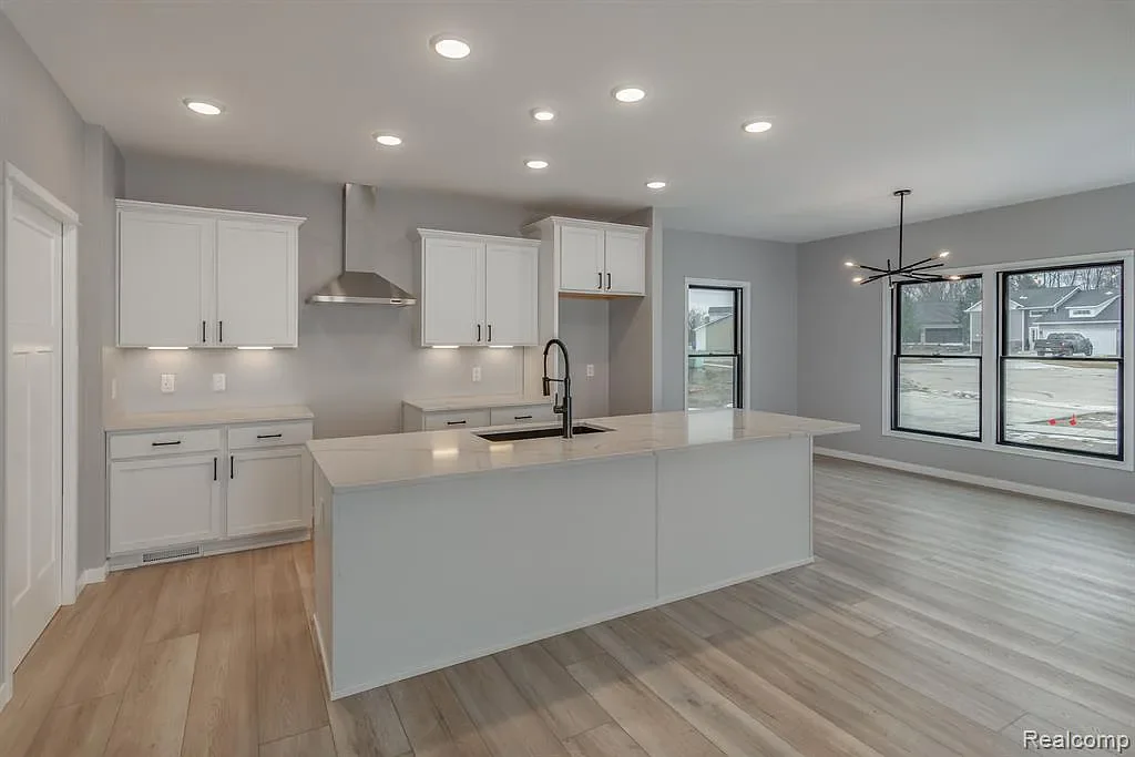 Kitchen with white cabinets and a quartz island