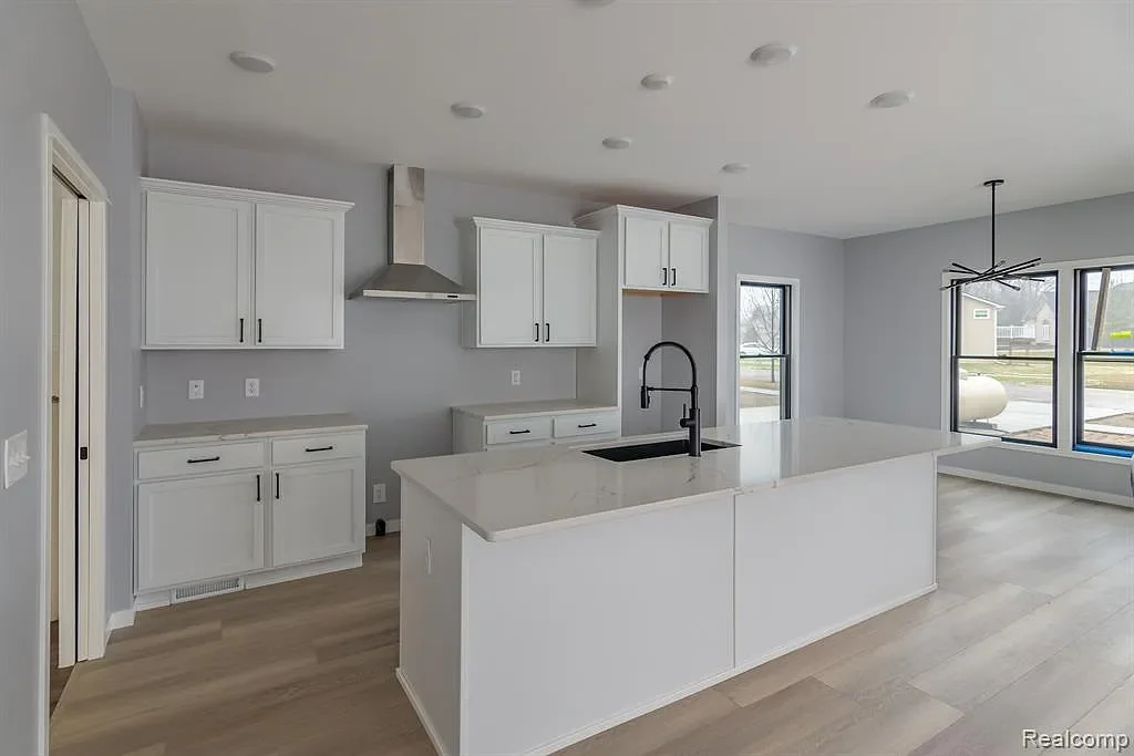 Kitchen with white cabinets and an island