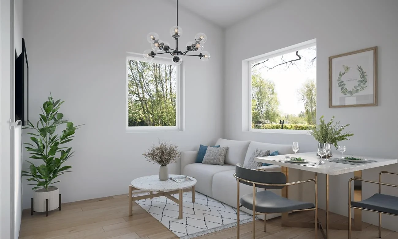 Rendering of the Pinwheel living area with a sofa, round coffee table, and dining table under a vaulted ceiling