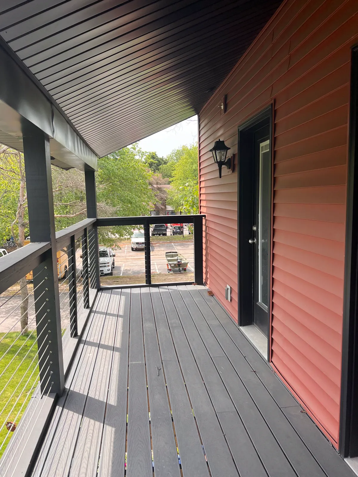 Covered upper balcony with cable railing and composite decking